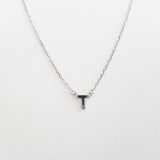 Necklace with a letter 'T' pendant on a white background