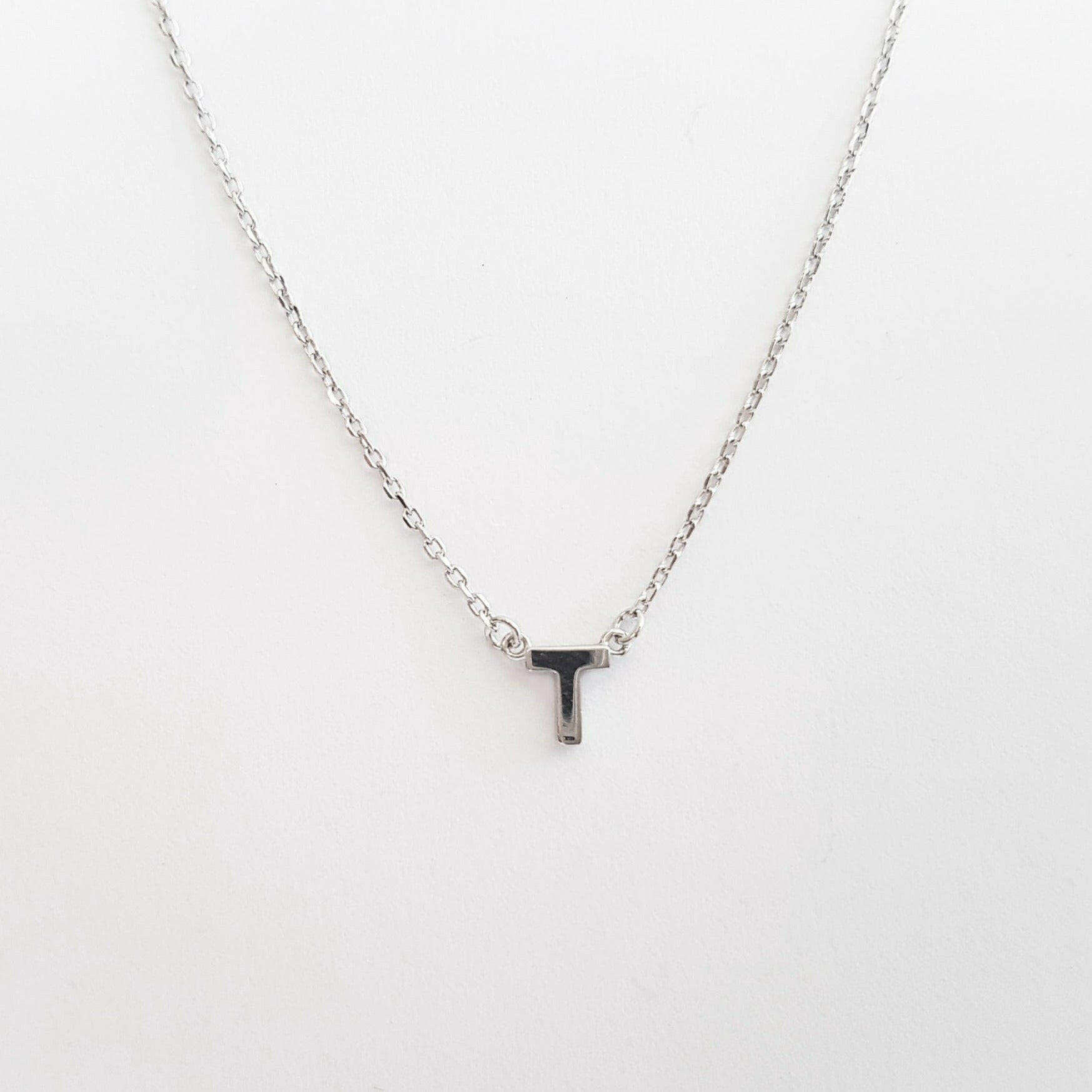 Necklace with a letter 'T' pendant on a white background