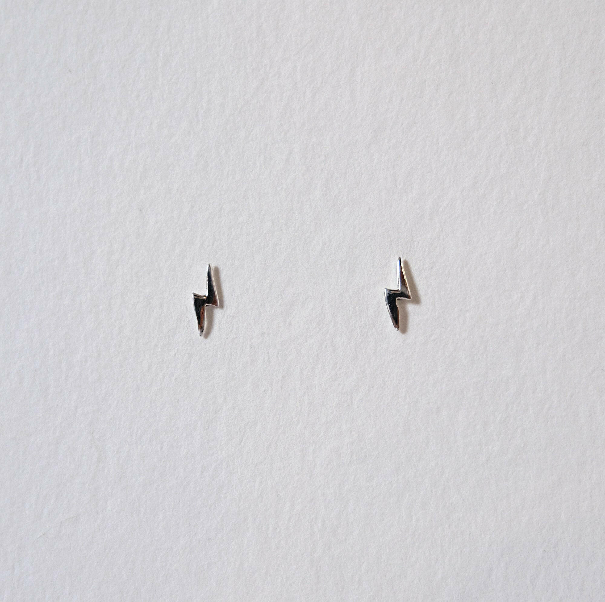 Sterling silver lightning bolt studs, tiny size, sleek and minimal design for elegant style