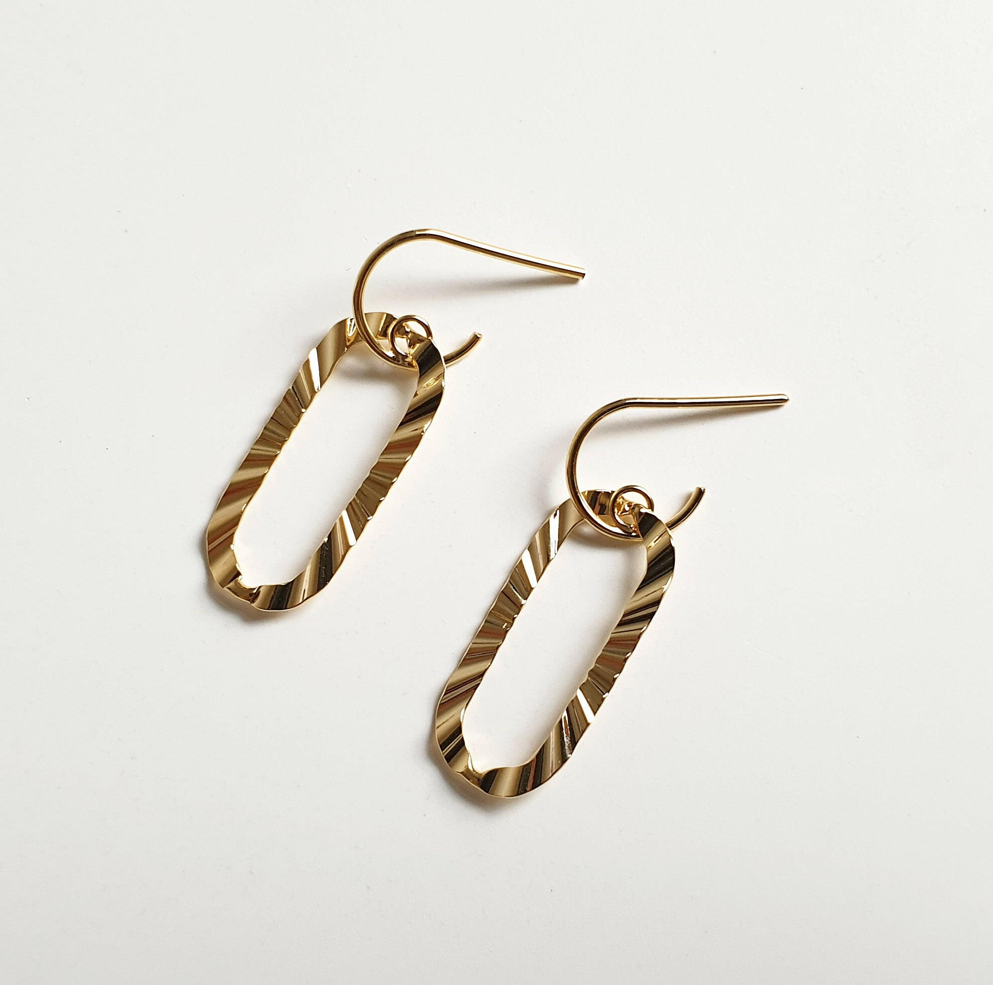 Signet hook earrings featuring a sculpted hollow oval shape for elegant and stylish jewelry design
